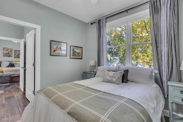 bedroom with ceiling fan and dark wood-type flooring