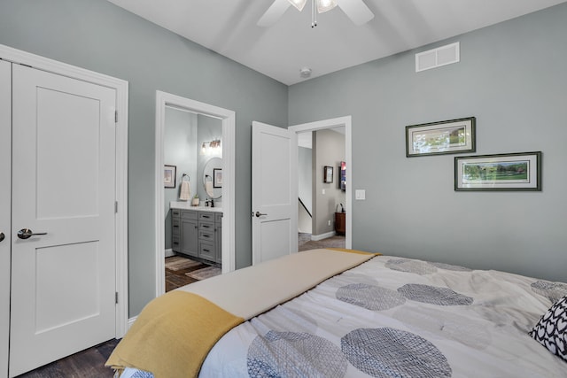 bedroom with ceiling fan, dark wood-type flooring, and connected bathroom