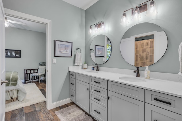 bathroom with wood-type flooring, vanity, and ceiling fan