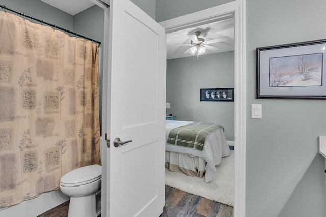 bathroom with hardwood / wood-style flooring, toilet, and ceiling fan