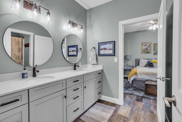 bathroom with ceiling fan, vanity, and wood-type flooring