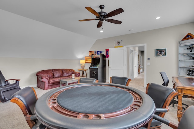 living room with ceiling fan, light colored carpet, and vaulted ceiling