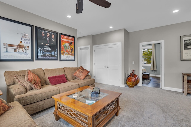 carpeted living room with ceiling fan