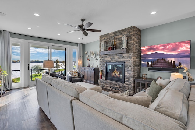 living room with a fireplace, ceiling fan, and hardwood / wood-style floors