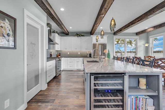 kitchen featuring hanging light fixtures, stainless steel appliances, wine cooler, beamed ceiling, and decorative backsplash