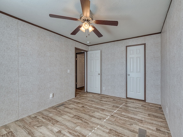 unfurnished bedroom with light wood-type flooring, ceiling fan, and crown molding