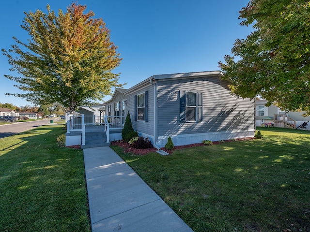 view of side of property with a lawn