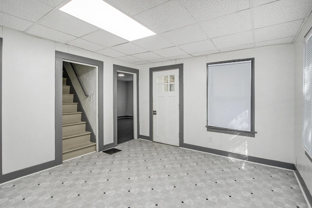 311 Bessie St, Kalamazoo, MI 49007 - below grade area with tile patterned floors, a paneled ceiling, baseboards, and stairs