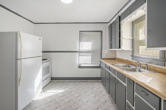 311 Bessie St, Kalamazoo, MI 49007 - kitchen featuring white appliances, a sink, gray cabinets, light flooring, and crown molding