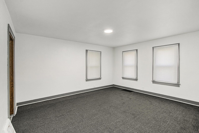 311 Bessie St, Kalamazoo, MI 49007 - unfurnished room with dark colored carpet and baseboards
