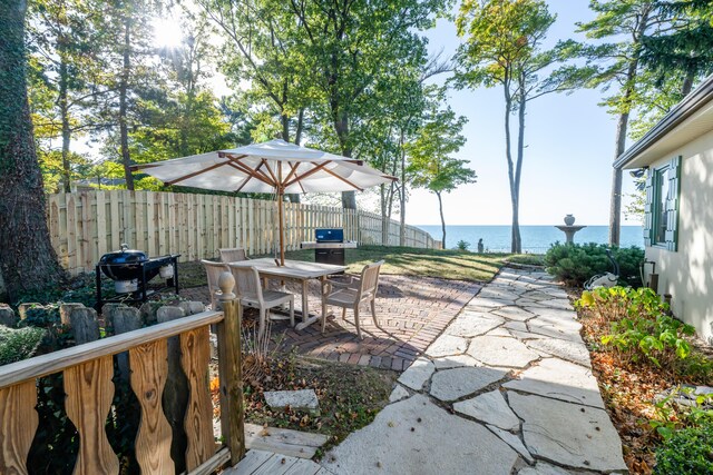 5876 Dunham Ln, Stevensville, MI 49127 - view of patio / terrace featuring a water view, outdoor dining area, and area for grilling