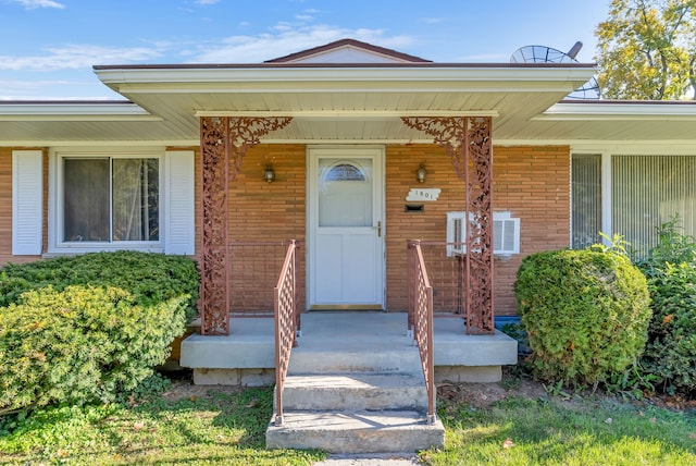 doorway to property featuring covered porch and central AC unit