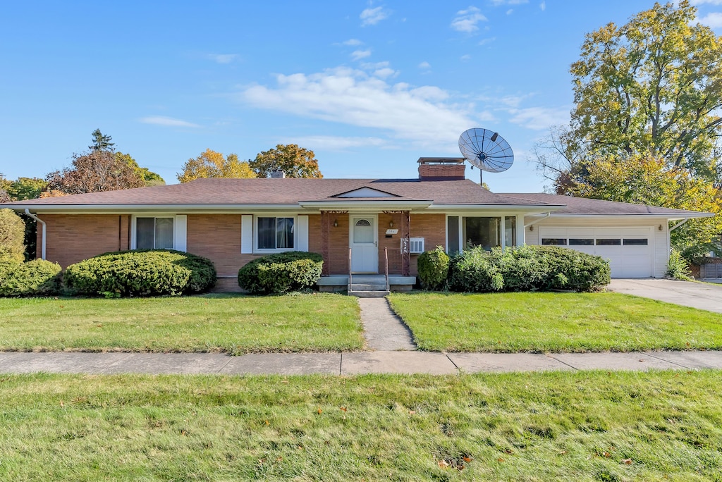 ranch-style house with a garage and a front yard