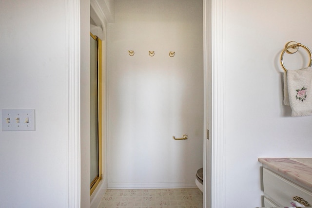 bathroom featuring toilet and an enclosed shower