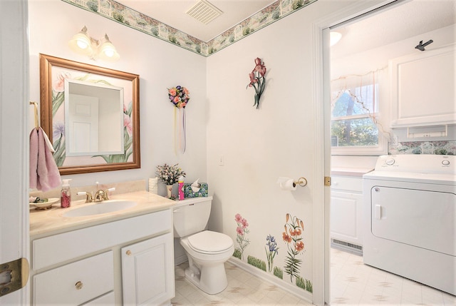 bathroom featuring vanity, washer / clothes dryer, and toilet