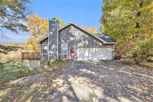 view of side of property featuring a deck and a garage