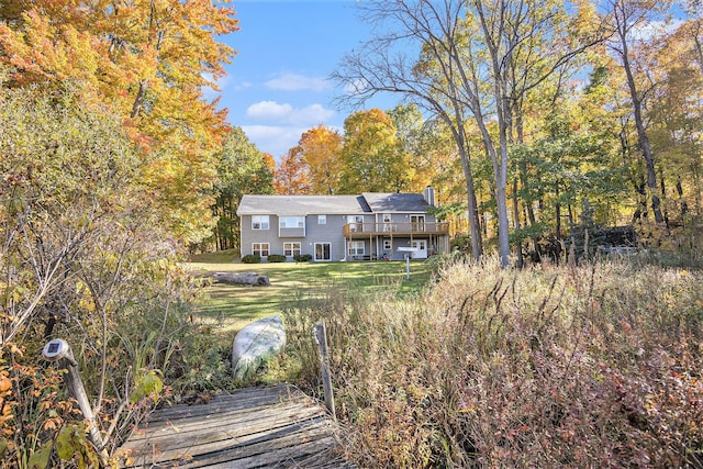 back of house featuring a deck and a yard