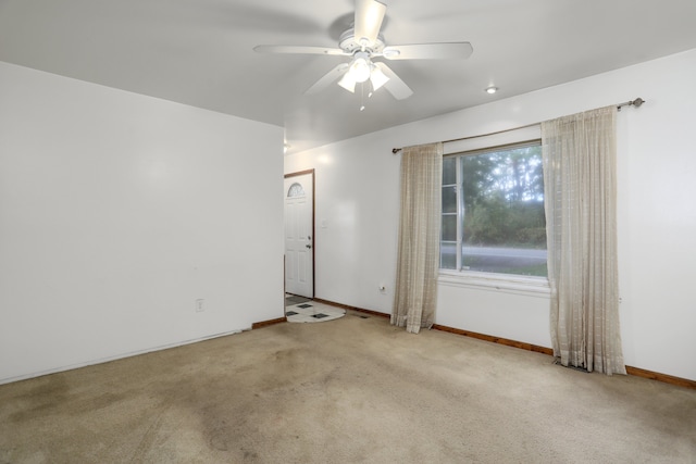 unfurnished room with ceiling fan and light colored carpet