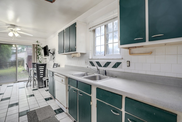 kitchen featuring sink, white dishwasher, decorative backsplash, light tile patterned flooring, and green cabinetry