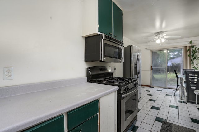 kitchen featuring ceiling fan, light tile patterned floors, green cabinetry, and appliances with stainless steel finishes