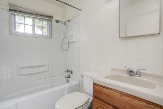 full bathroom featuring vanity, tiled shower / bath combo, and toilet