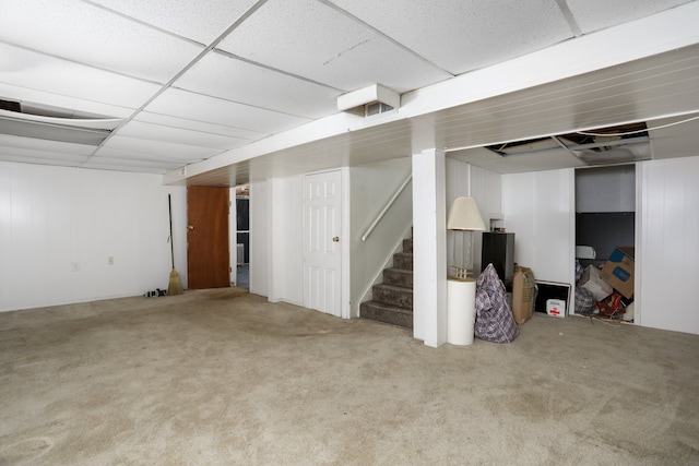 basement with a drop ceiling and carpet floors