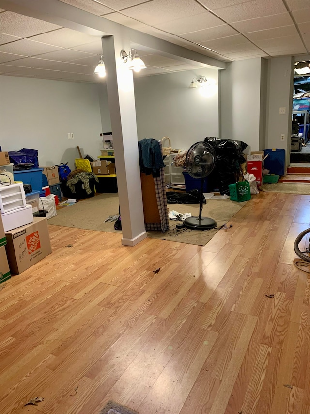 basement with wood-type flooring and a drop ceiling