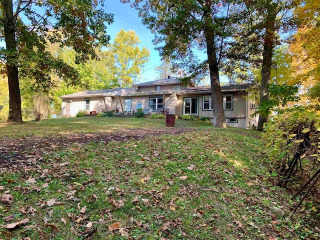 rear view of house with a lawn