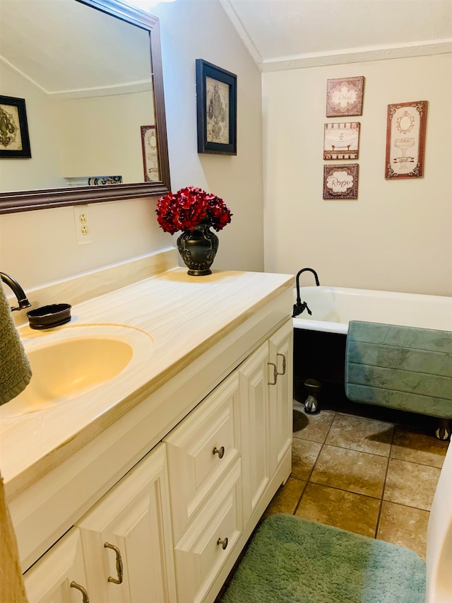 bathroom featuring crown molding, vanity, and a bath