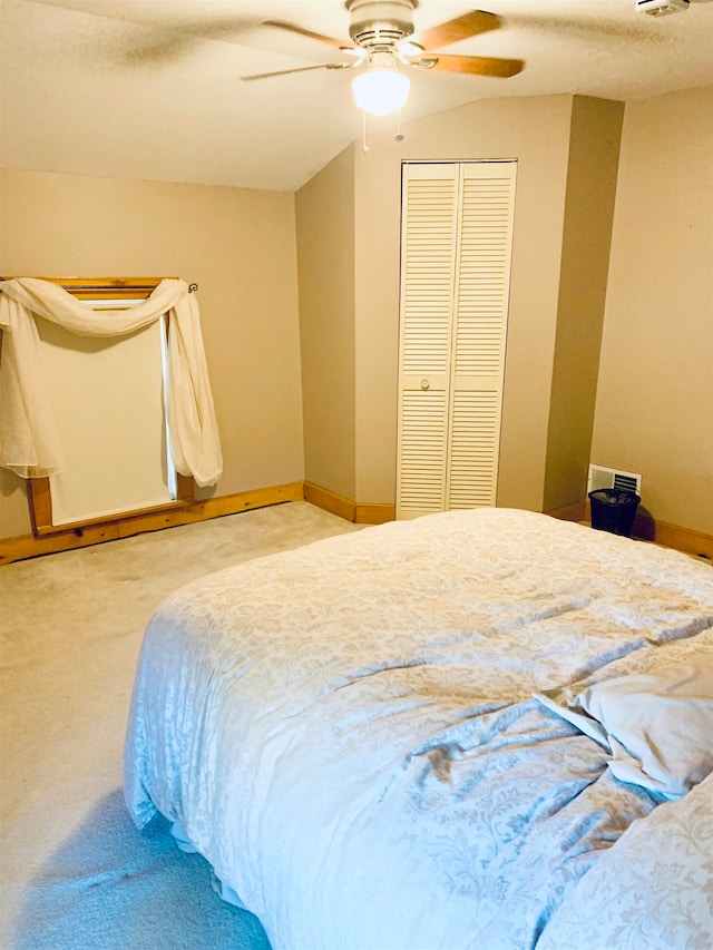 carpeted bedroom featuring a closet and ceiling fan