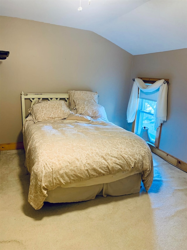 carpeted bedroom featuring vaulted ceiling