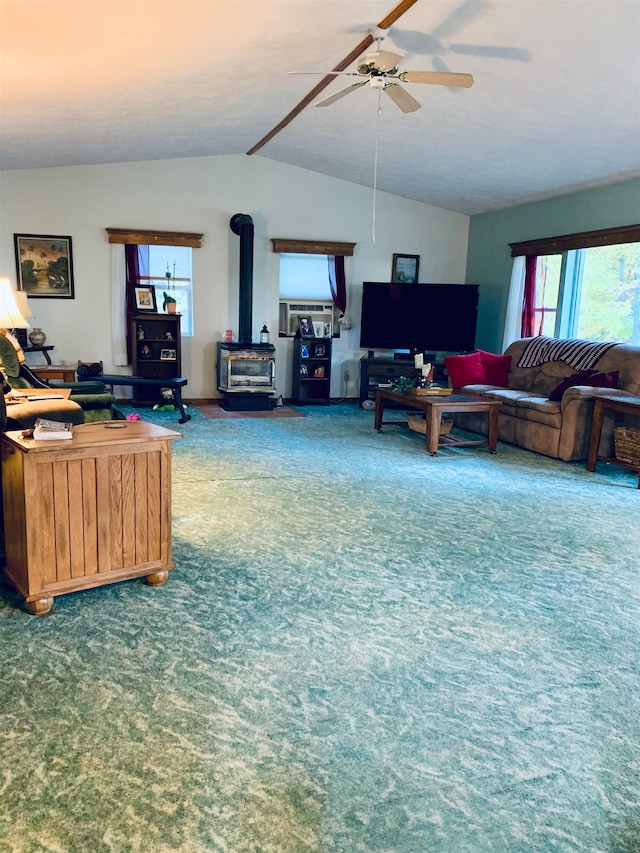 living room with a wood stove, carpet floors, and vaulted ceiling