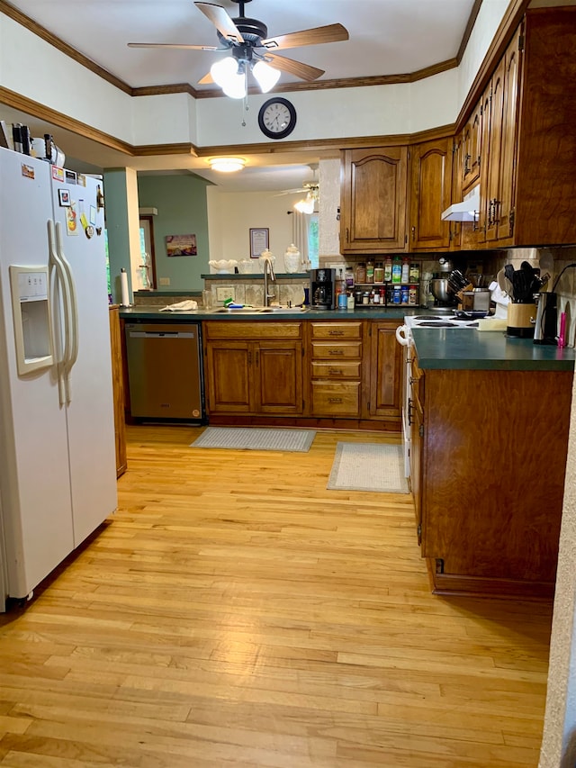 kitchen featuring stove, light wood-type flooring, sink, dishwasher, and white fridge with ice dispenser