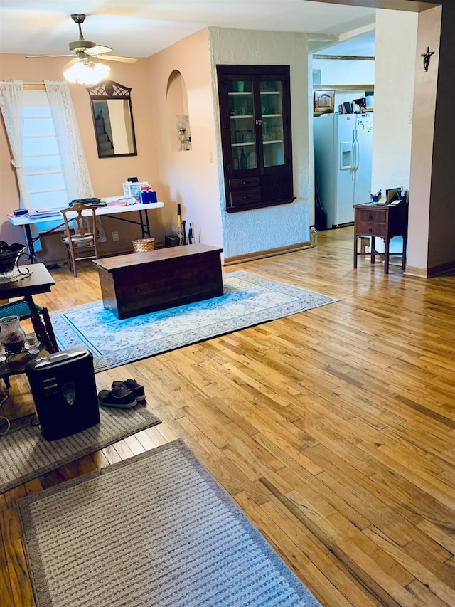 living room featuring ceiling fan and light hardwood / wood-style flooring