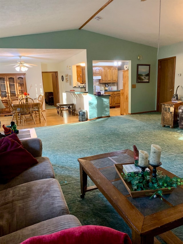 living room with ceiling fan, light wood-type flooring, and lofted ceiling