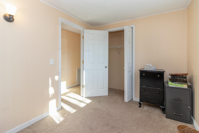 unfurnished bedroom with light carpet and a closet