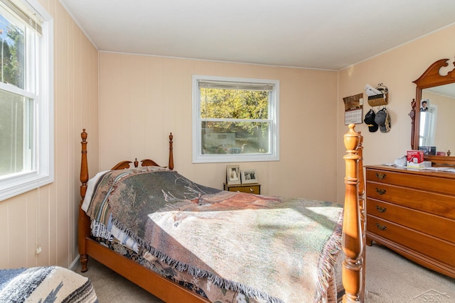 carpeted bedroom with wooden walls