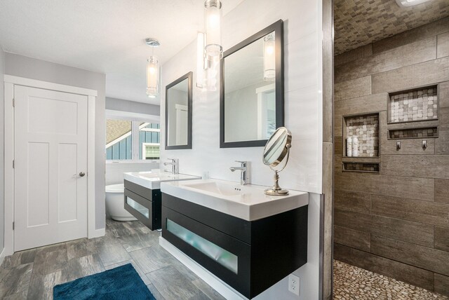 bathroom featuring vanity, wood-type flooring, and walk in shower