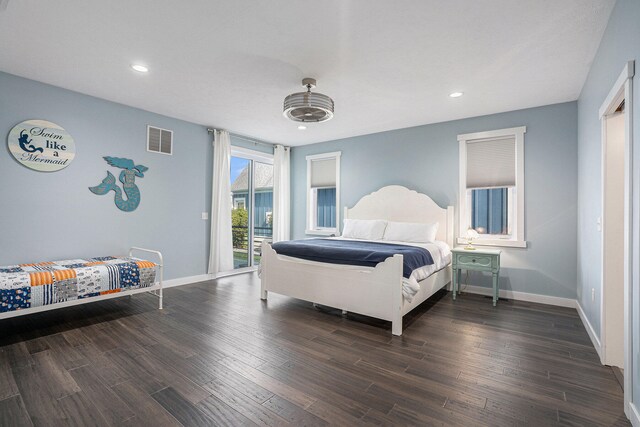 bedroom with access to outside and dark wood-type flooring