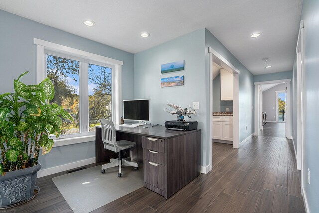 office with dark hardwood / wood-style flooring