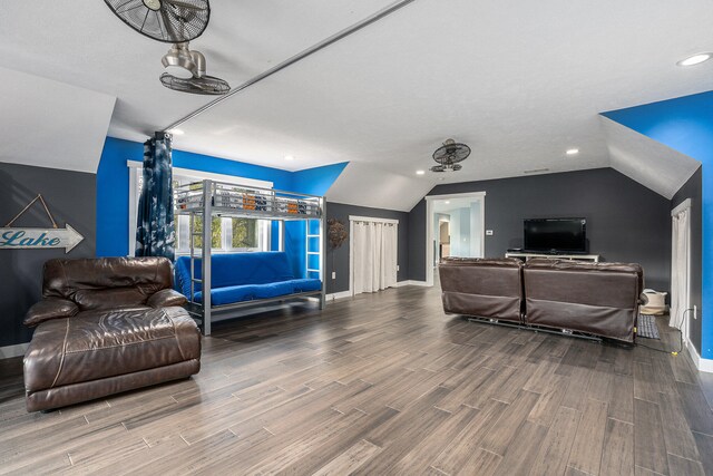 living room with lofted ceiling, wood-type flooring, and a textured ceiling