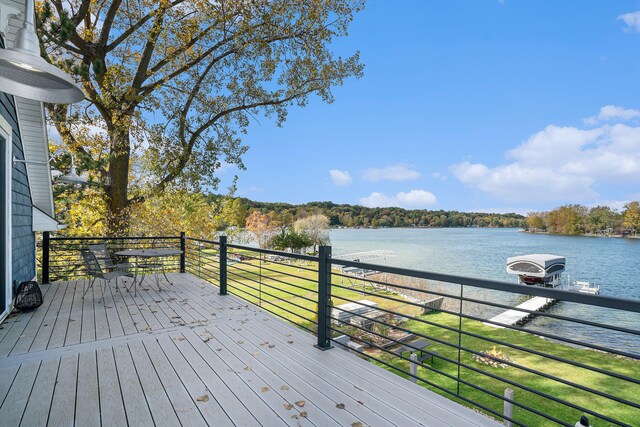 wooden deck featuring a yard and a water view