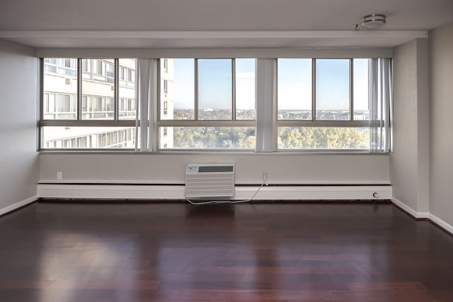 spare room with dark hardwood / wood-style flooring and a wall mounted air conditioner