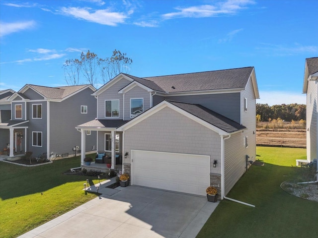 view of front facade with a front yard, a garage, and covered porch