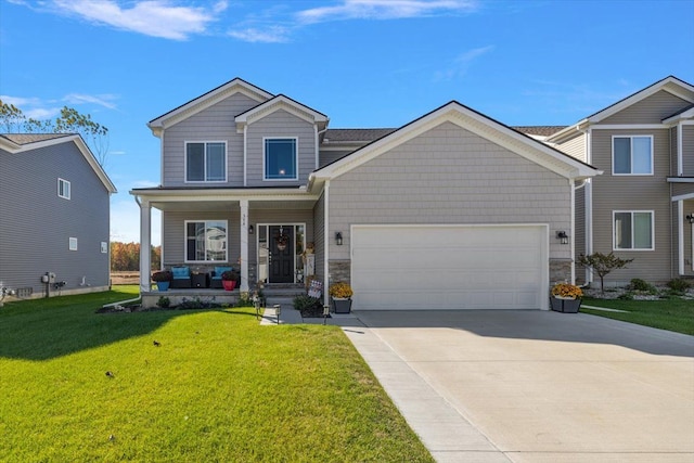 view of front of house featuring a porch, a garage, and a front lawn