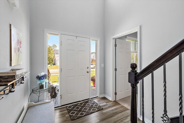 entryway featuring a high ceiling and hardwood / wood-style flooring