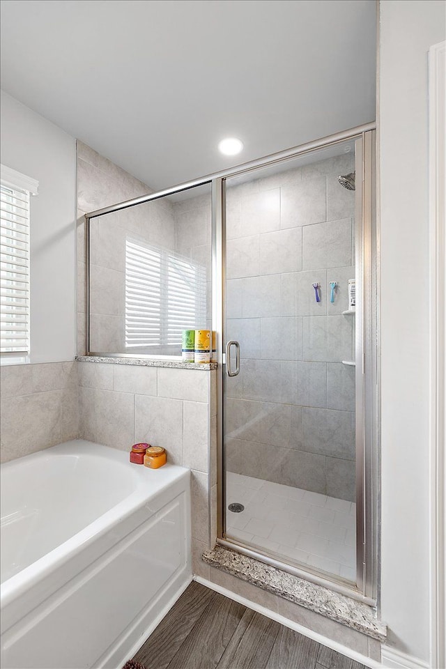 bathroom with shower with separate bathtub