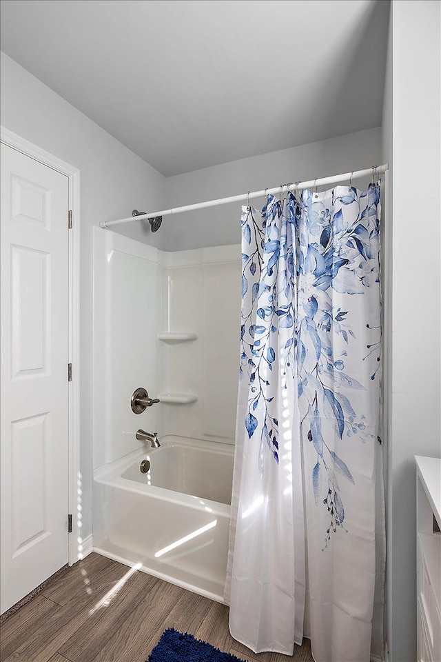 bathroom featuring hardwood / wood-style floors and shower / bath combination with curtain