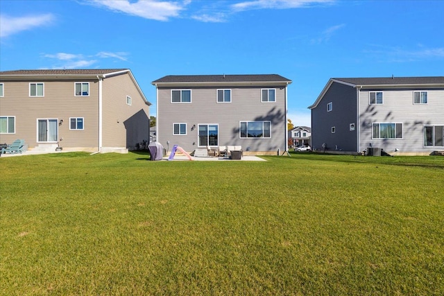 rear view of house with a patio area and a yard