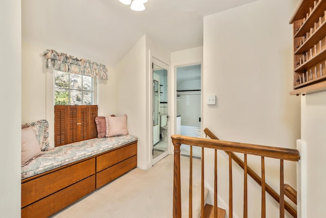 sitting room featuring light colored carpet